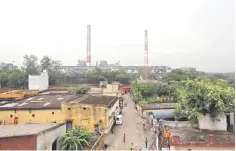  ??  ?? Chimneys of a coal-fired power plant are pictures in New Delhi, India. Indian power companies are seeking billions of dollars of federal funding to retrofit coal-fired plants to cut emissions, saying hefty tariff increases would otherwise be needed to pay for the technology, according to internal documents. — Reuters photo