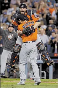  ?? AP/MATT SLOCUM ?? Houston Astros catcher Brian McCann leaps into the arms of Charlie Morton after the Houston Astros defeated the Los Angeles Dodgers to win the 2017 World Series in seven games. There are plenty of story lines among the teams battling to see who will win the World Series this season.