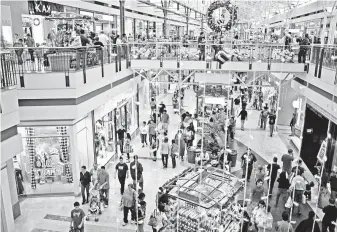  ?? Eric S. Swist / Staff file photo ?? Shoppers descended on The Woodlands Mall last holiday season. Deloitte says the most popular gifts in Houston include gift cards, clothing, toys, food and liquor, and books.