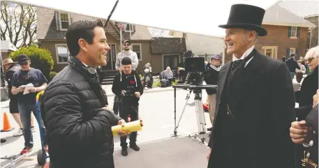  ??  ?? Murdoch Mysteries director and star, Yannick Bisson, left, shares a laugh with actor Colm Feore on the set of the long-running program.