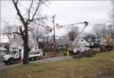  ?? Photos by Ernest A. Brown/The Call ?? Crews from National Grid work to restore power to residents along Great Road in Lincoln on Saturday, after large trees took down power lines during Friday’s late-winter nor’easter.