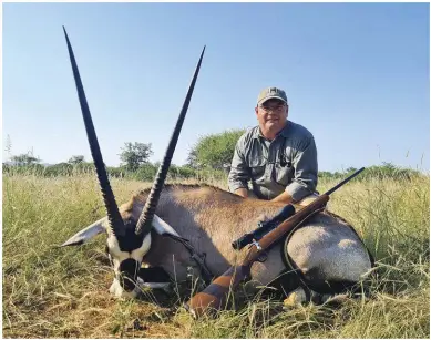  ??  ?? TOP: Johan with the downed gemsbuck bull after the hunt.