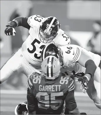  ?? RON SCHWANE/AP PHOTOS ?? The Browns’ Myles Garrett (95) is taken down by the Steelers’ David DeCastro, right, and Maurkice Pouncey on Nov. 14.