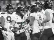  ?? ASSOCIATED PRESS ?? OREGON’S CYRUS HABIBI-LIKIO (center) celebrates his second-quarter touchdown against Arizona during Saturday’s game in Eugene, Ore.