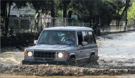  ?? Austin Dave/The Signal ?? A man in an Izuzu Trooper drives through deep floodwater on Crown Valley Road near Soledad Canyon Road in Acton last year. Santa ClarIta City Council voted to direct staff to revise letter that would have asked members of Congress to support climate.