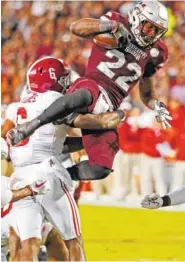  ?? THE ASSOCIATED PRESS ?? Mississipp­i State running back Aeris Williams, top, is tackled by Alabama defensive back Hootie Jones during Saturday’s game in Starkville, Miss.