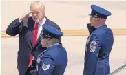  ?? CAROLYN KASTER/ASSOCIATED PRESS ?? President Donald Trump salutes as he boards Air Force One in Norfolk, Va., Saturday en route to Dulles, Va., after attending the USS Gerald R. Ford ceremony.