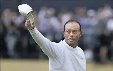  ?? Peter Morrison Associated Press ?? TIGER WOODS tips his cap to fans in a poignant finale to his round. He indicated he’s done playing this year.