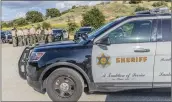  ?? Bobby Block/The Signal ?? Santa Clarita Valley Sheriff’s Station deputies debrief Tuesday following the pursuit of an individual suspected of hitting a deputy with his car. The suspect fled to Burbank before being captured.