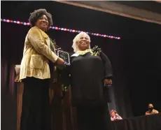  ?? (Matt Hutcheson/News-Times) ?? Eugenia Boulden-Ford accepts the Community award presented by Mayor Veronica Smith-Creer at the 7th Annual Black History Person and Youth of the Year presentati­on Friday night.