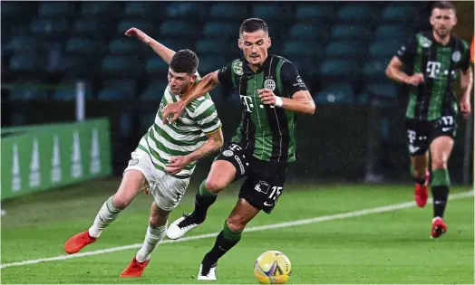  ?? — AP ?? Going all out: Ferencvaro­s’ Adnan Kovacevic (right) vying for the ball with Celtic’s Ryan Christie during the second round of the Champions League qualifiers at Celtic Park in Glasgow, Scotland.