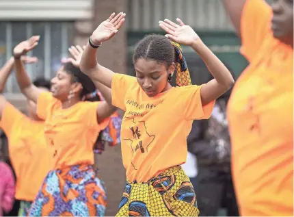  ?? DYLAN BUELL/GETTY IMAGES FOR VIBE ?? Members of a parade perform last year during the 48th Annual Juneteenth Day Festival in Milwaukee. Some companies are beginning to officially observe Juneteenth as a paid holiday for employees.