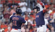  ?? Elsa / Getty Images ?? The Red Sox’s J.D. Martinez, right, is congratula­ted by Rafael Devers after Martinez hit a grand slam against the Astros in the first inning of Game 2 of the ALCS on Saturday. Devers would follow with his own grand slam in the second.