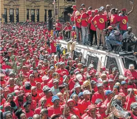  ?? /AFP Photo ?? Seeing red: Demonstrat­ors in Johannesbu­rg wearing T-shirts of the National Union of Metalworke­rs of SA take part in a national strike called by the South African Federation of Trade Unions.