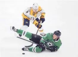  ?? RICHARD W. RODRIGUEZ/AP ?? The Predators’ Rocco Grimaldi trips Stars center Ty Dellandrea on Sunday. So far this season, games are averaging more than seven penalties apiece.