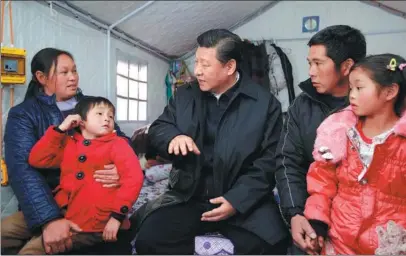  ?? JU PENG / XINHUA ?? President Xi Jinping meets with villagers from quake-ravaged Ludian county, Yunnan province, at a temporary shelter in January 2015. The area was hit by a magnitude 6.5 earthquake in August 2014, leaving at least 617 people dead and 112 missing.