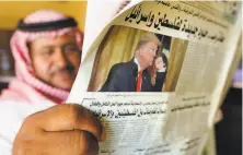  ?? Amr Nabil / Associated Press ?? A Saudi man reads a newspaper at a coffee shop in Jiddah after President Trump unveiled his Mideast peace plan.