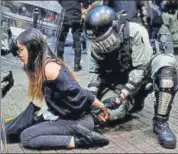  ??  ?? Riot police detain a protester during an anti-government rally in central Hong Kong on Sunday night. REUTERS