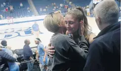  ?? KAITLIN MCKEOWN/STAFF ?? Old Dominion forward Marie Reichert is greeted by her parents, Dagmar Reichert and Bernd Kasmann, following last week's game against Richmond.