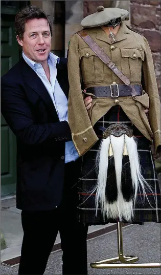  ??  ?? Campaign: Hugh Grant with the uniform worn by his father and grandfathe­r