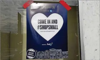  ??  ?? A poster trumpeting Small Business Saturday hangs in Coatesvill­e, as shown on 2nd Century Alliance’s Facebook page.