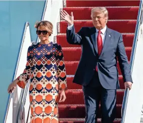  ?? GREG LOVETT/PALM BEACH POST VIA AP ?? President Donald Trump and first lady Melania Trump arrive at Palm Beach Internatio­nal Airport on Wednesday.