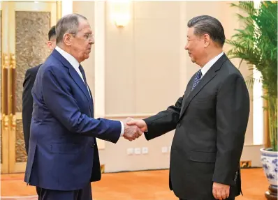  ?? (Li Xueren/xinhua via AP) ?? In this photo released by Xinhua News Agency, Russian Foreign Minister Sergey Lavrov, left, and Chinese President Xi Jinping meets at the Great Hall of the People in Beijing on Tuesday. China has surged sales to Russia of machine tools, microelect­ronics and other technology that Moscow in turn is using to produce missiles, tanks, aircraft and other weaponry. That’s according to two senior Biden administra­tion officials who discussed the sensitive findings on the condition of anonymity.
