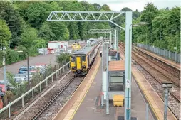  ?? ALEX AYRE ?? POWERING AHEAD: Progress electrifyi­ng the Valley Lines from Cardiff Central is starting to show in a number of locations, particular­ly at Radyr, where Class 153
No. 153303 waits time on August 22 with the 13.32 Transport for Wales service to Coryton.