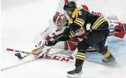  ?? AP ?? Carolina Hurricanes’ Antti Raanta (left) and Boston Bruins’ Connor Clifton vie for control of the puck.