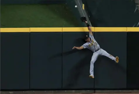  ?? Associated Press ?? Cole Tucker just missed making a catch Friday night on a three-run home run hit by Reds batter Nick Castellano­s in the Reds 8-1 win in Cincinnati — a play that caused his mother to text him after the game.