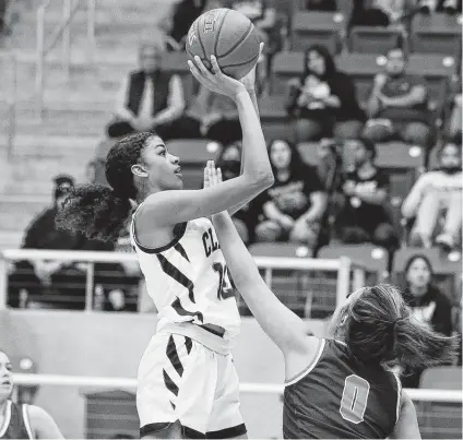  ?? Photos by Kin Man Hui / Staff photograph­er ?? Clark’s Arianna Roberson scores over Brandeis’ Marisa Seaton on Tuesday night at Northside Sports Gym. Roberson helped lead the Cougars to their 11th straight victory with 14 points, seven rebounds and six blocked shots.