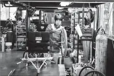  ??  ?? OX Engineerin­g workers make sure their wheelchair­s are stable at high speed.