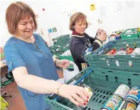  ??  ?? Angela Wilson, left, and Kirsteen Macdonald making up some of the 100 food parcels CFine deliver daily