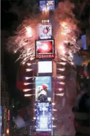  ?? THE ASSOCIATED PRESS ?? Fireworks erupt as the clock strikes midnight during the New Year’s celebratio­n in Times Square as seen from the Marriott Marquis in New York, Monday, Jan. 1, 2018.