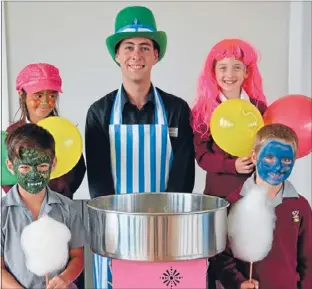  ??  ?? Yay for Friday: Candyfloss Heaven’s Julian Avisenis, with St Pius X School students, from left, Mason Ikin-katene, Zha’dynya Sutherland, Alisha Gillon and Liam Mcvicar, getting in some practice for their school’s Fabulous Friday Food and Fun Fair.