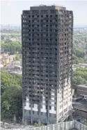  ?? REUTERS ?? The burnt-out remains of Grenfell Tower are seen in North Kensington, London on Sunday.