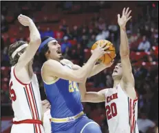  ?? Associated Press ?? UCLA guard Jaime Jaquez Jr. (24) shoots against Utah center Branden Carlson (left) and guard Lazar Stefanovic (20) during the first half on Thursday in Salt Lake City.