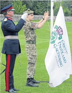  ?? Picture: Phil Hannah. ?? Cadet Sgt Harry Path hoists the flag to mark the 150th anniversar­y of Crieff Highland Gathering after the event was cancelled due to coronaviru­s. Perth and Kinross Lord Lieutenant Stephen Leckie, who was due to be chieftain this year, stands by at the ceremony while a film to celebrate the gathering’s milestone year was also concluded.