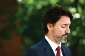  ?? Tang/The Canadian Press via AP) (Justin ?? Prime Minister Justin Trudeau speaks Thursday during a news conference on the COVID-19 pandemic outside his residence at Rideau Cottage in Ottawa.