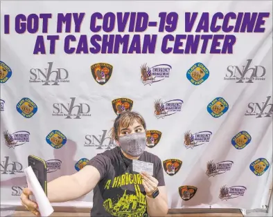  ?? K.M. Cannon Las Vegas Review-journal @Kmcannonph­oto ?? Micah Haji-sheikh, 27, takes a selfie after receiving her COVID-19 vaccine at Cashman Center. Shot eligibilit­y expanded Tuesday to all groups in the front-line community support and front-line supply chain and logistics categories.