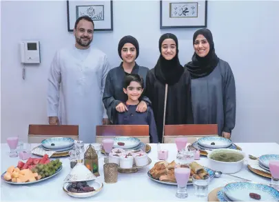  ?? Victor Besa / The National ?? Fathima Mansoor Ahmed, right, brings her time growing up in South Africa to her dishes during iftar with her family, from left, Maseeh, Maryam, Zahraa and, front, Muhammad, to keep things fresh and healthy