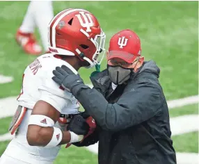  ?? JOSEPH MAIORANA/USA TODAY SPORTS ?? Indiana coach Tom Allen, right, hugs defensive back Devon Matthews before the Hoosiers’ game against against Ohio State.