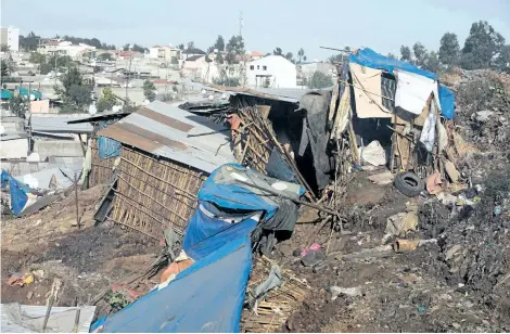  ?? ZACHARIUS ABUBEKER/AFP/GETTY IMAGES ?? Damaged dwellings are seen after a landslide in the main city dump of Addis Ababa, Ethiopia, left at least 35 people dead on Saturday night. Dozens more were hurt or missing following the giant landslide at Ethiopia’s largest rubbish dump outside the...