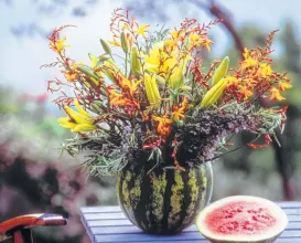  ?? Courtesy photo ?? Create a vase from a watermelon and fill with Asiatic lilies and crocosmia.