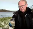  ??  ?? TOXIC: Jim Cusack with a sample of contaminat­ed water from a stream near Castleblan­ey in Co Monaghan