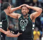  ??  ?? John Henson consoles Jabari Parker after Parker missed a potential tying shot in overtime.