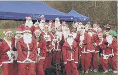  ??  ?? FESTIVE FUN: Stainland Lions runners get into the spirit of Christmas at the Overgate Santa Dash. Pic: Sarah Parker