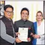  ?? HT ?? Singer Adnan Sami, along with his wife Roya Faryabi, receives the document of Indian citizenshi­p from Union minister Kiren Rijiju in New Delhi.