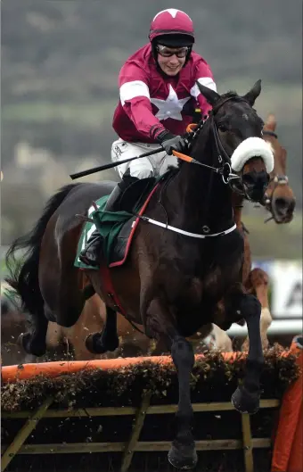  ??  ?? Champagne Classic, ridden by J.J. Slevin, clears the last on the way to winning the Martin Pipe Conditiona­l Jockeys’ Handicap Hurdle at last year’s Cheltenham Festival.