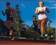  ??  ?? Santa Cruz High sophomore Jim Ratliff, right, shines in a cross country race against Pacific Collegiate School on Thursday. Ratliff won the 3,200-meter race with a time of 10:11. PCS freshman Spencer Koontz, left, finished second at 10:38.